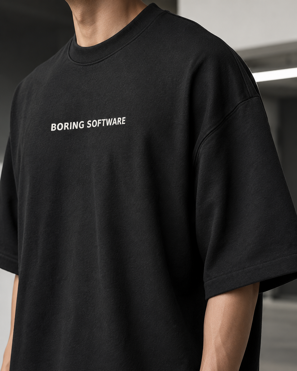 Person wearing a black t-shirt with 'BORING SOFTWARE' text.