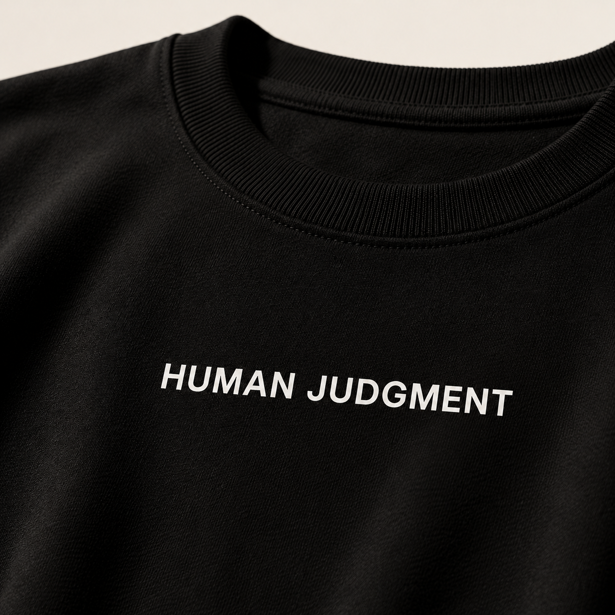 Close-up of HUMAN JUDGMENT print on black heavyweight terry fabric