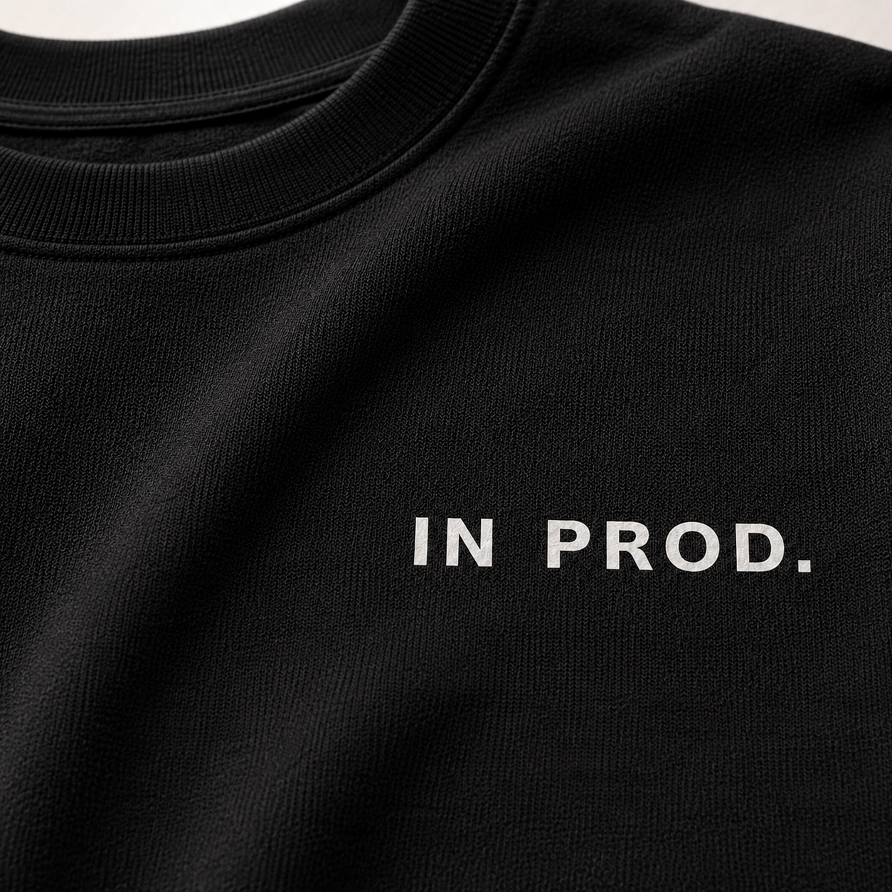 Black sweatshirt with 'IN PROD.' text on a plain background