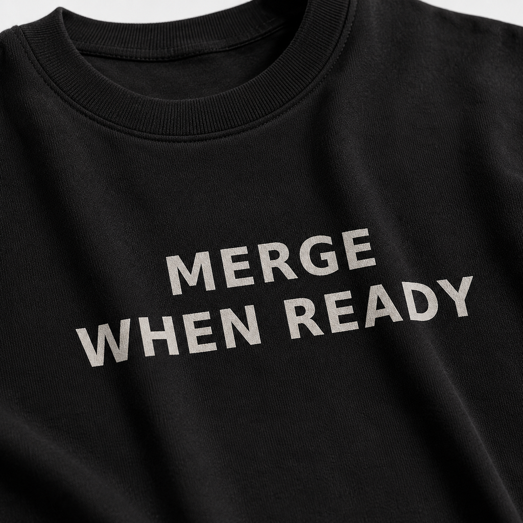 Black sweatshirt with 'MERGE WHEN READY' text on a plain background